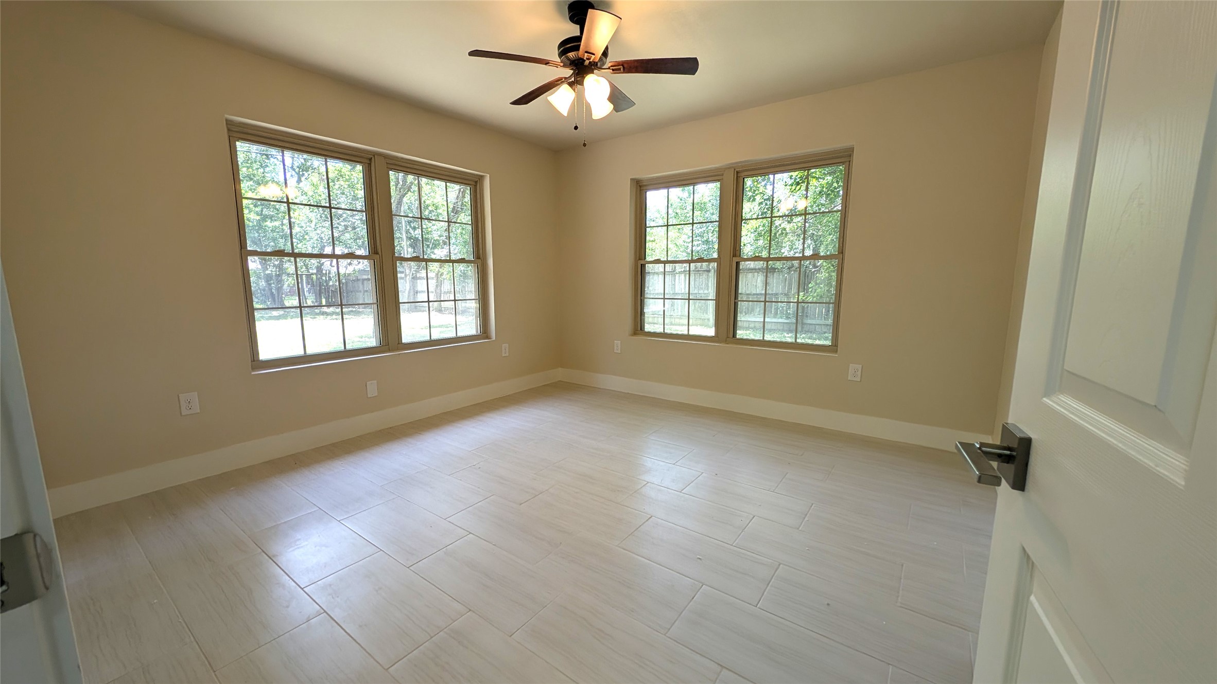 11811 Sleepy Hollow Road Manchaca, TX 78652 - Photo 19 of 31 an empty room with wooden floor chandelier fan and windows