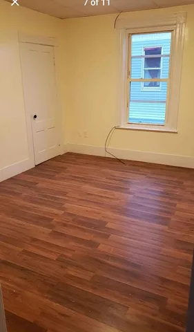 a view of a room with wooden floor and windows