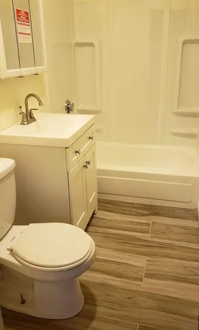 a white toilet sitting next to a bathroom sink