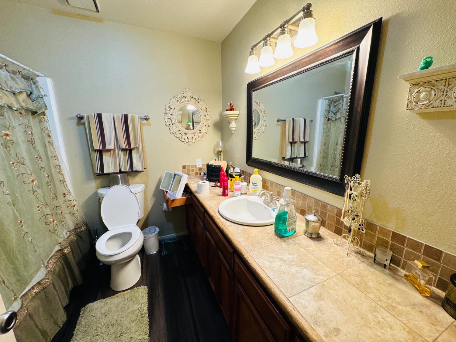 7675 North First Street, Unit 202 Fresno, CA 93720 - Photo 17 of 19 a bathroom with a granite countertop sink mirror vanity and toilet