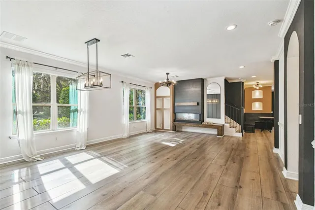 a view of an empty room with a fireplace and a window