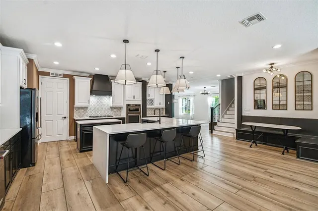 a large kitchen with a table and chairs