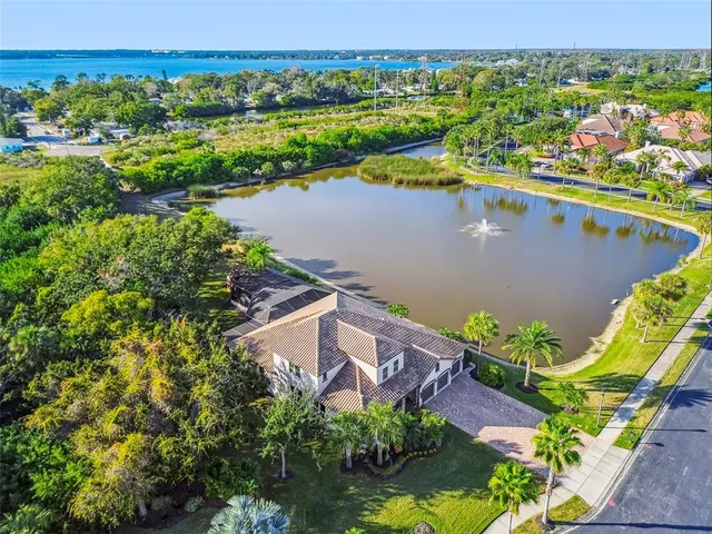 an aerial view of a residential houses with outdoor space and swimming pool