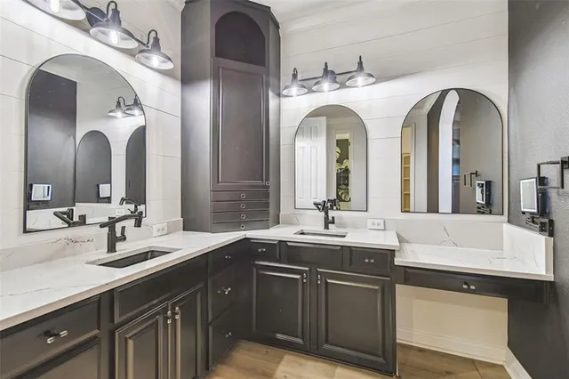 a view of an empty room with wooden floor and a ceiling fan