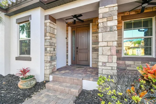 a view of a hallway with wooden floor and a living room
