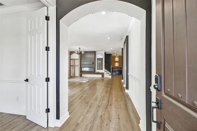 a view of a hallway with wooden floor and staircase