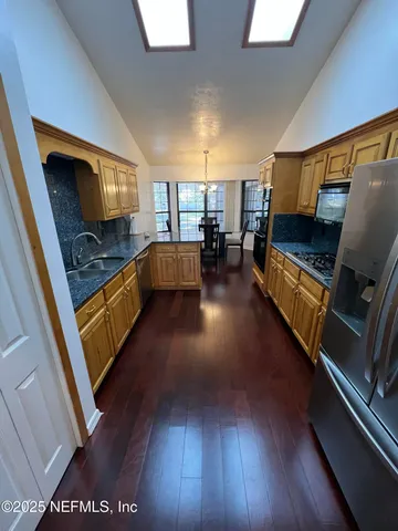 a utility room with cabinets washer and dryer