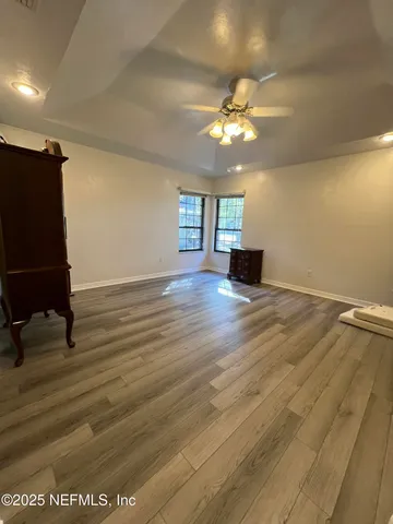 a bathroom with a granite countertop sink and white cabinets