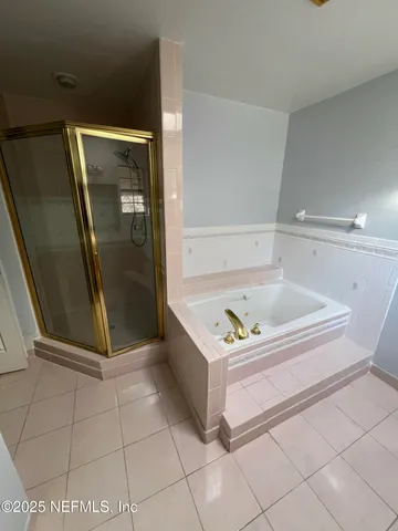 a bedroom with a bed and a ceiling fan