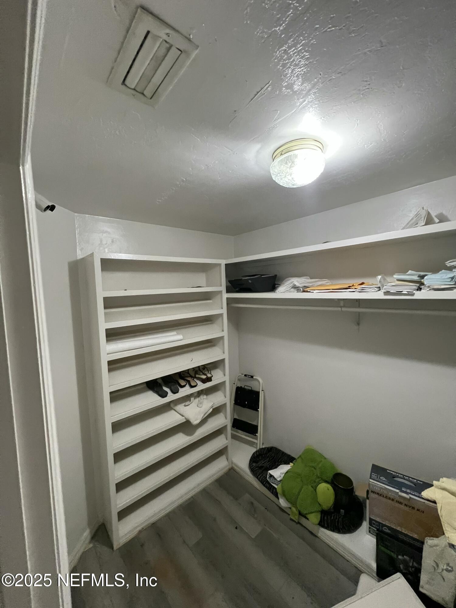 1825 Raiford Road Starke, FL 32091 - Photo 27 of 92 a view of walk in closet with clothes and shoes