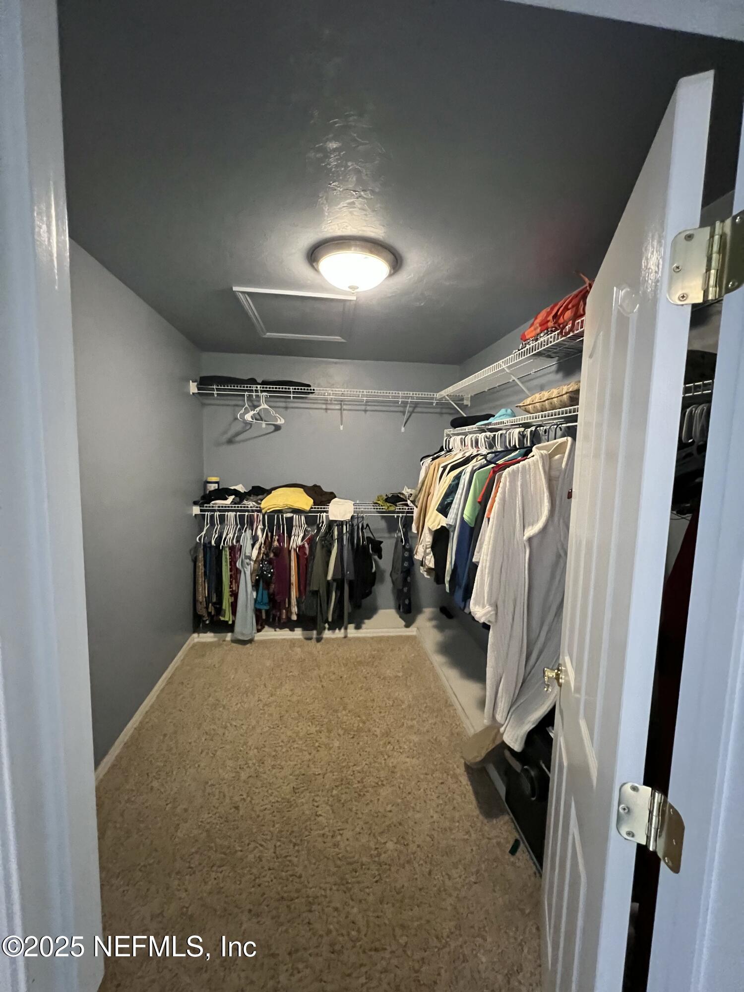 1825 Raiford Road Starke, FL 32091 - Photo 30 of 92 a view of walk in closet with clothes and shoes