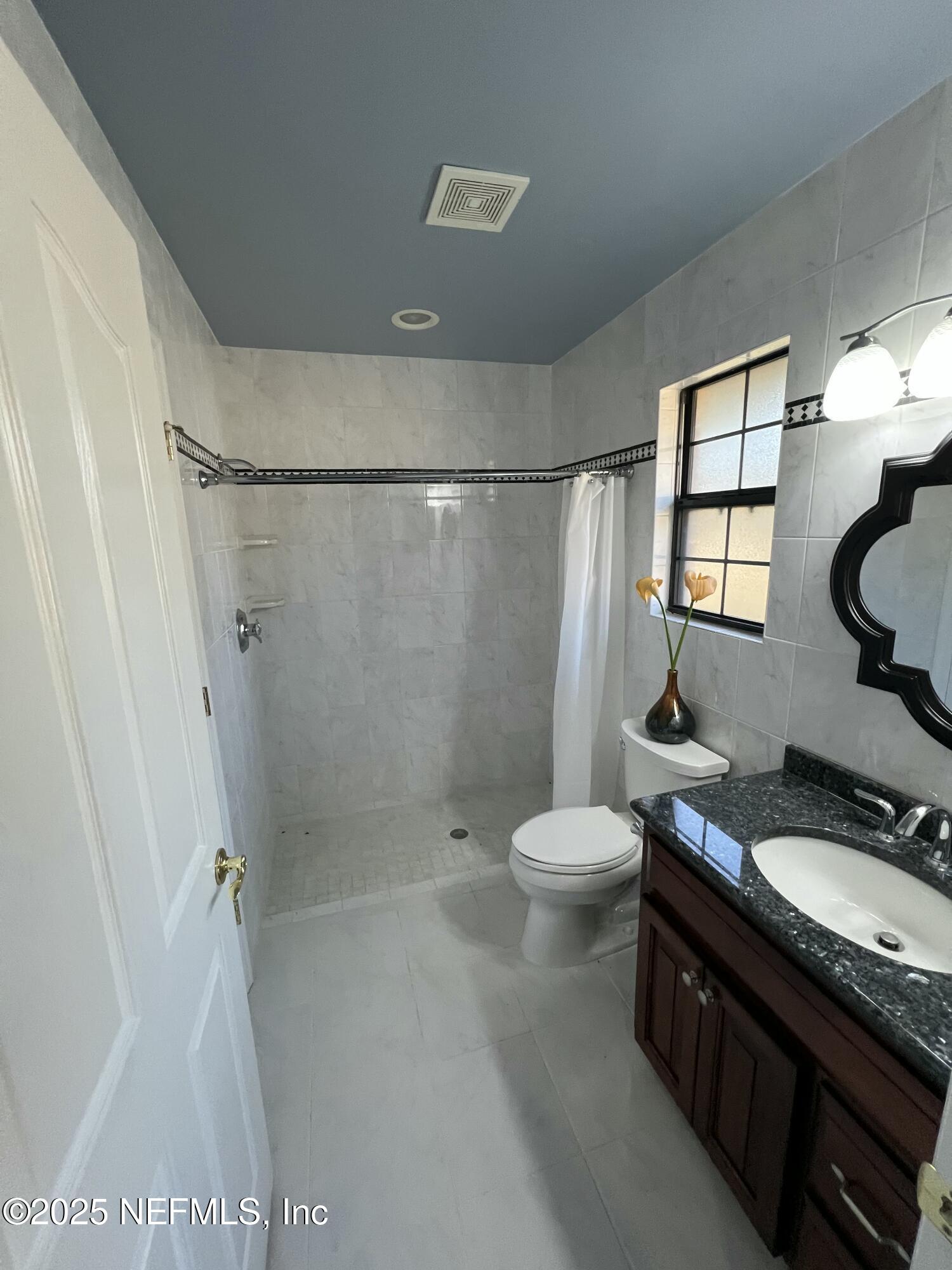 1825 Raiford Road Starke, FL 32091 - Photo 41 of 92 a bathroom with a granite countertop sink toilet and shower