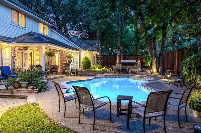 a dining room with furniture and a potted plant