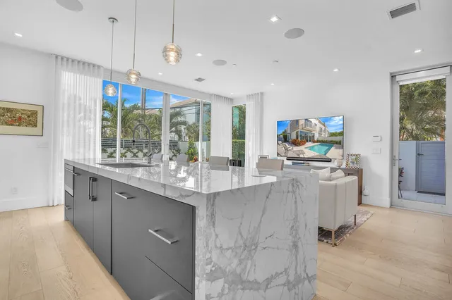 a kitchen with stainless steel appliances granite countertop a sink and a refrigerator