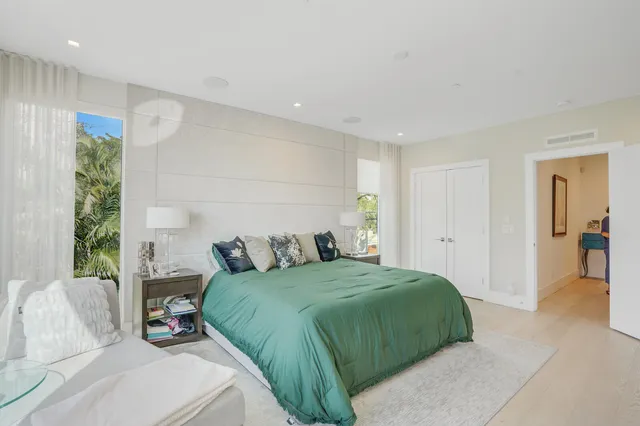 a bedroom with a bed and glass window