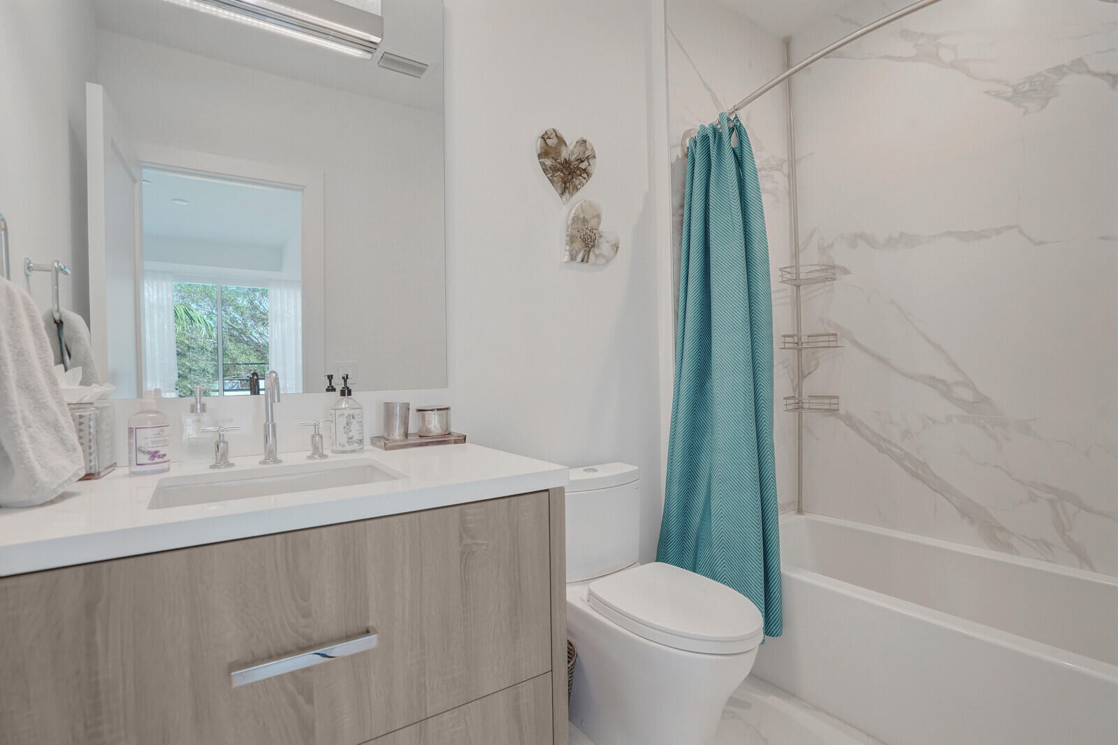 200 Northeast 7th Avenue, Unit 3 Delray Beach, FL 33483 - Photo 28 of 71 a bathroom with a sink a toilet and shower