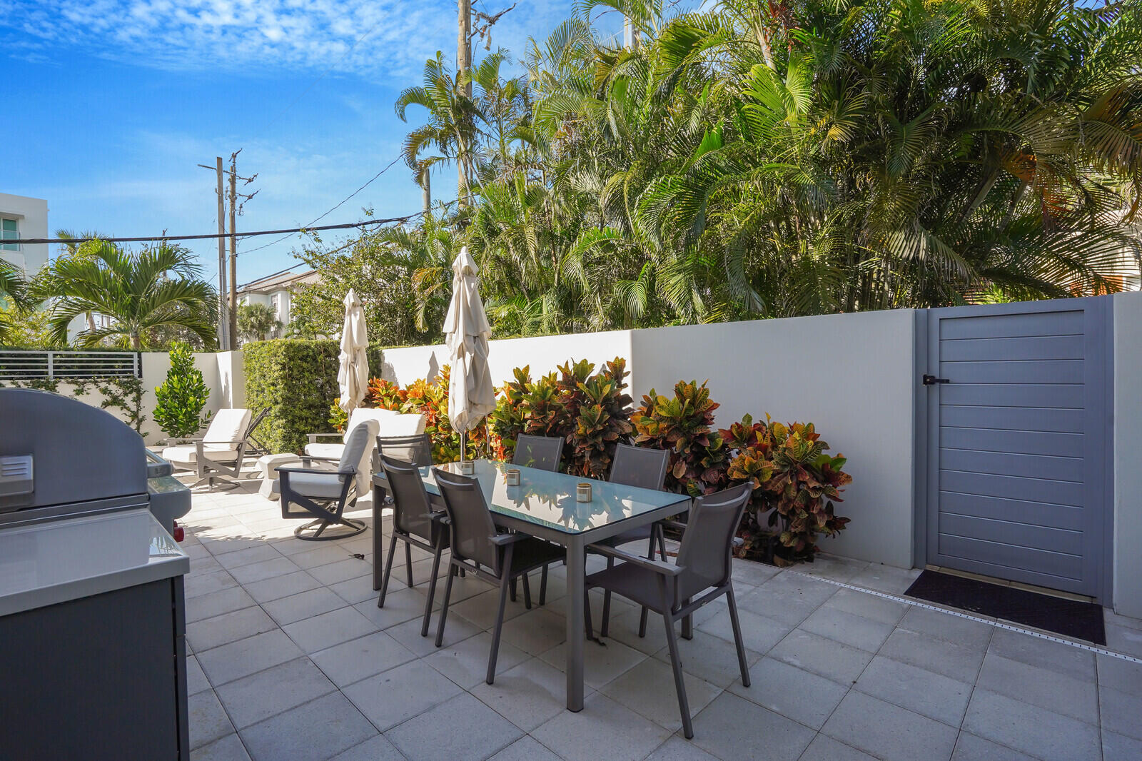 200 Northeast 7th Avenue, Unit 3 Delray Beach, FL 33483 - Photo 43 of 71 a view of a patio with a table and chairs and potted plants