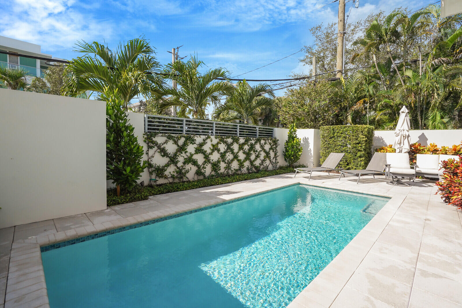 200 Northeast 7th Avenue, Unit 3 Delray Beach, FL 33483 - Photo 47 of 71 a view of a swimming pool with a lounge chair