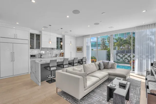 a living room with stainless steel appliances kitchen island granite countertop furniture and a view of kitchen