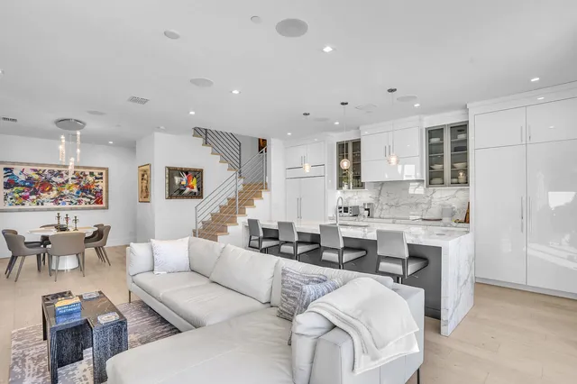 a large kitchen with granite countertop a large counter top and stainless steel appliances