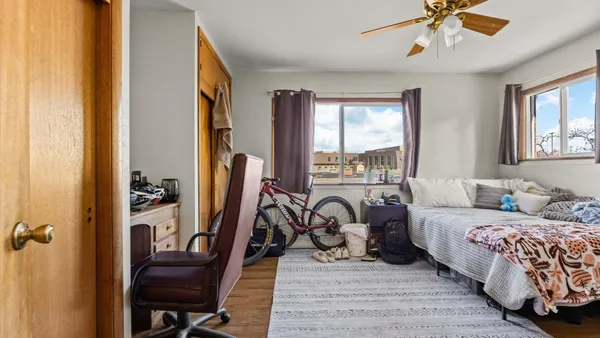 a bedroom with a bed and a chandelier