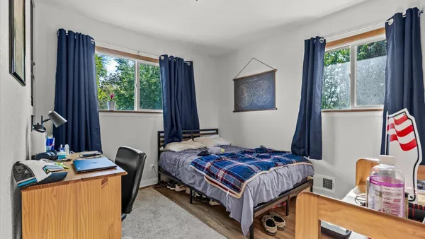 a bedroom with a bed and a window