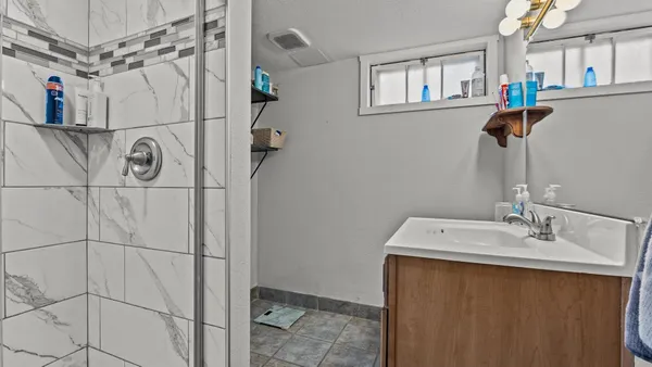 a bathroom with a sink and mirror