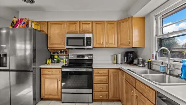 a kitchen with stainless steel appliances granite countertop a refrigerator stove and sink