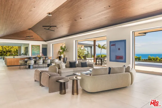 a view of a patio with table and chairs and potted plants