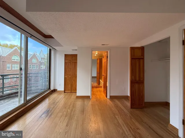 a view of empty room with wooden floor