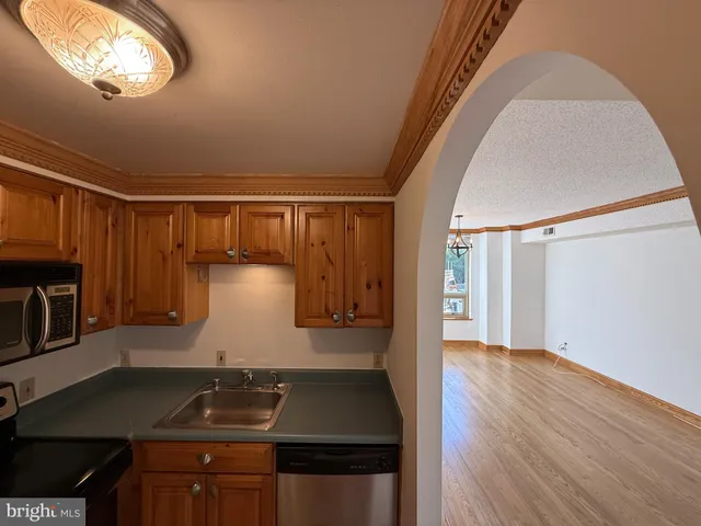 a kitchen with wooden floor and a stove