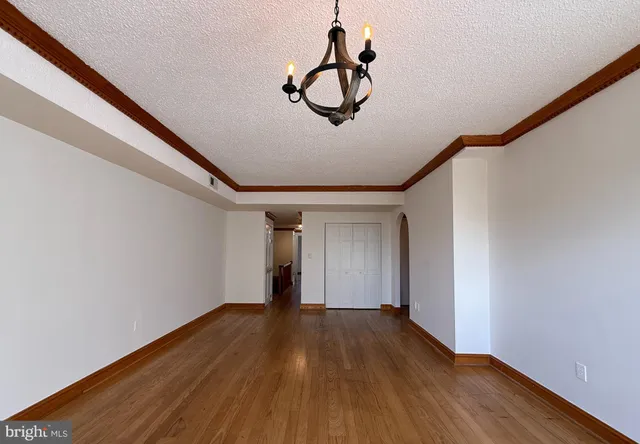 a view of room with wooden floor and ceiling fan