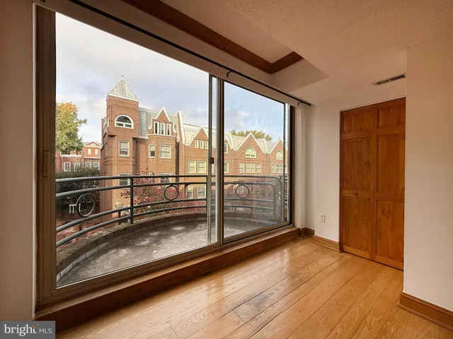 a view of a room with wooden floor and windows