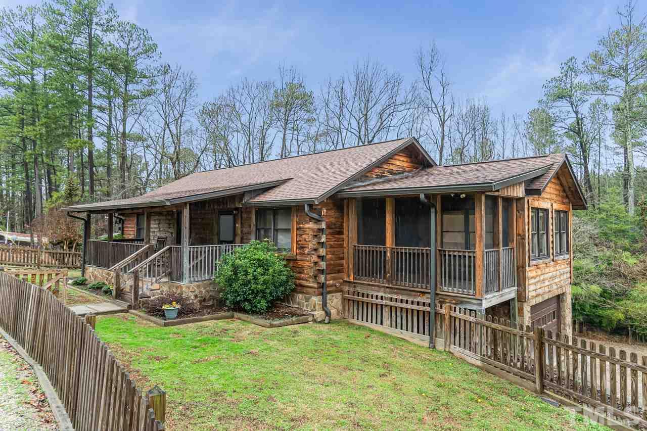 148 Nutbush Road Manson, NC 27553 - Photo 1 of 30 a front view of a house with a yard table and chairs