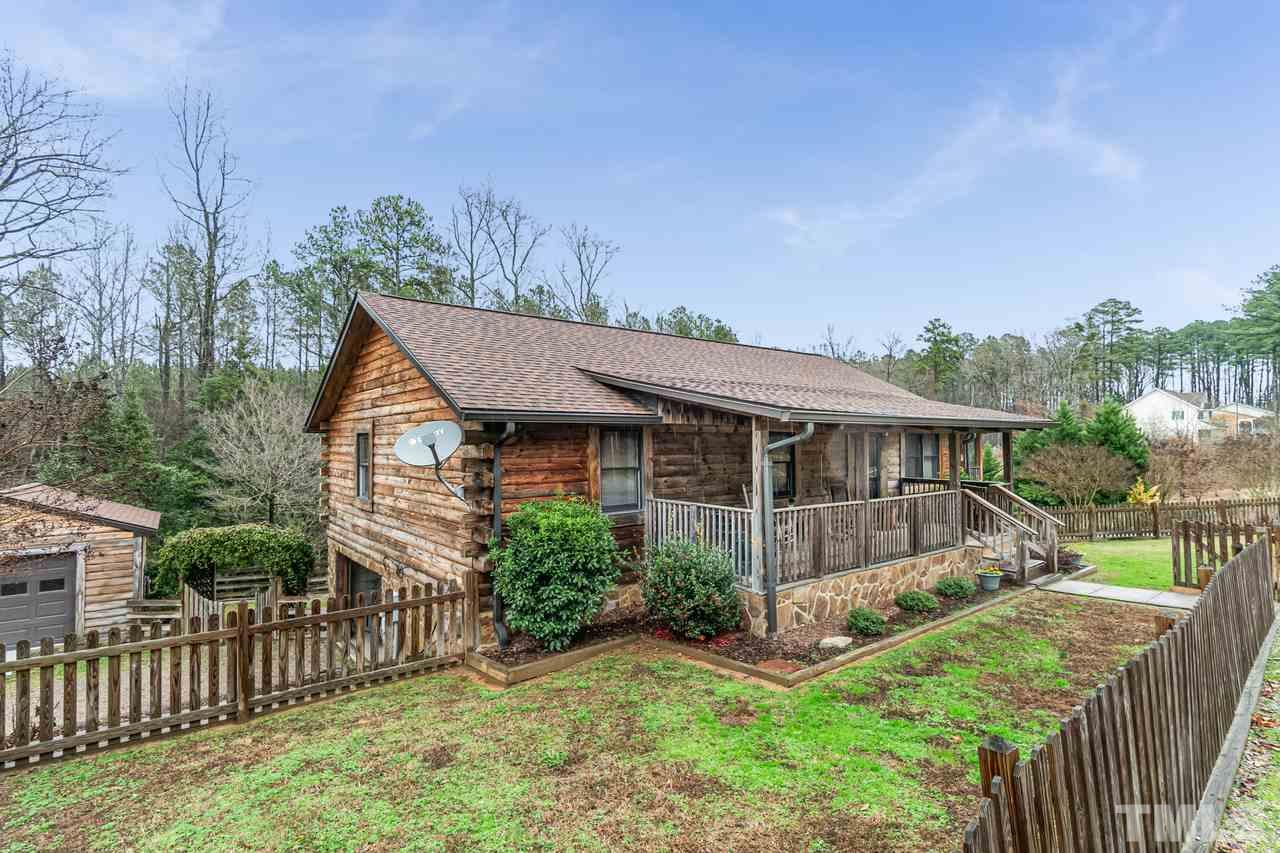 148 Nutbush Road Manson, NC 27553 - Photo 2 of 30 a view of a house with wooden fence next to a yard