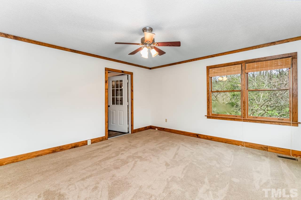 148 Nutbush Road Manson, NC 27553 - Photo 14 of 30 an empty room with windows and chandelier fan