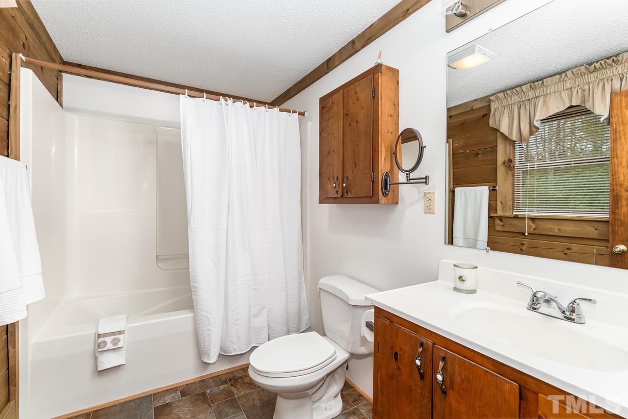 148 Nutbush Road Manson, NC 27553 - Photo 21 of 30 a bathroom with a sink a toilet and shower curtain