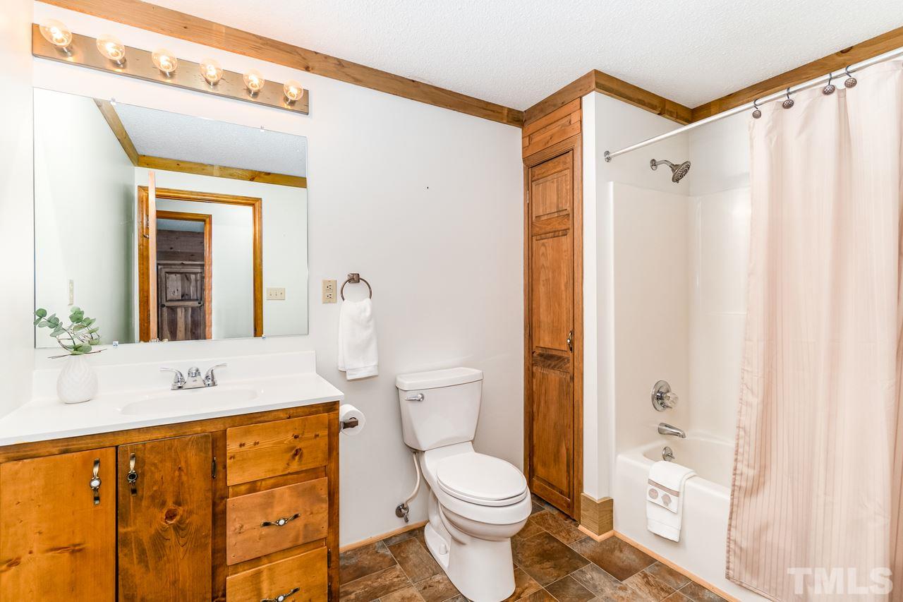 148 Nutbush Road Manson, NC 27553 - Photo 22 of 30 a bathroom with a sink a toilet and shower curtain
