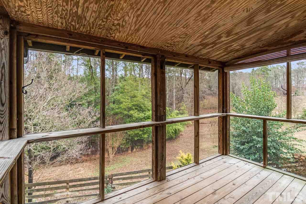 148 Nutbush Road Manson, NC 27553 - Photo 24 of 30 a view of a wooden deck next to a yard