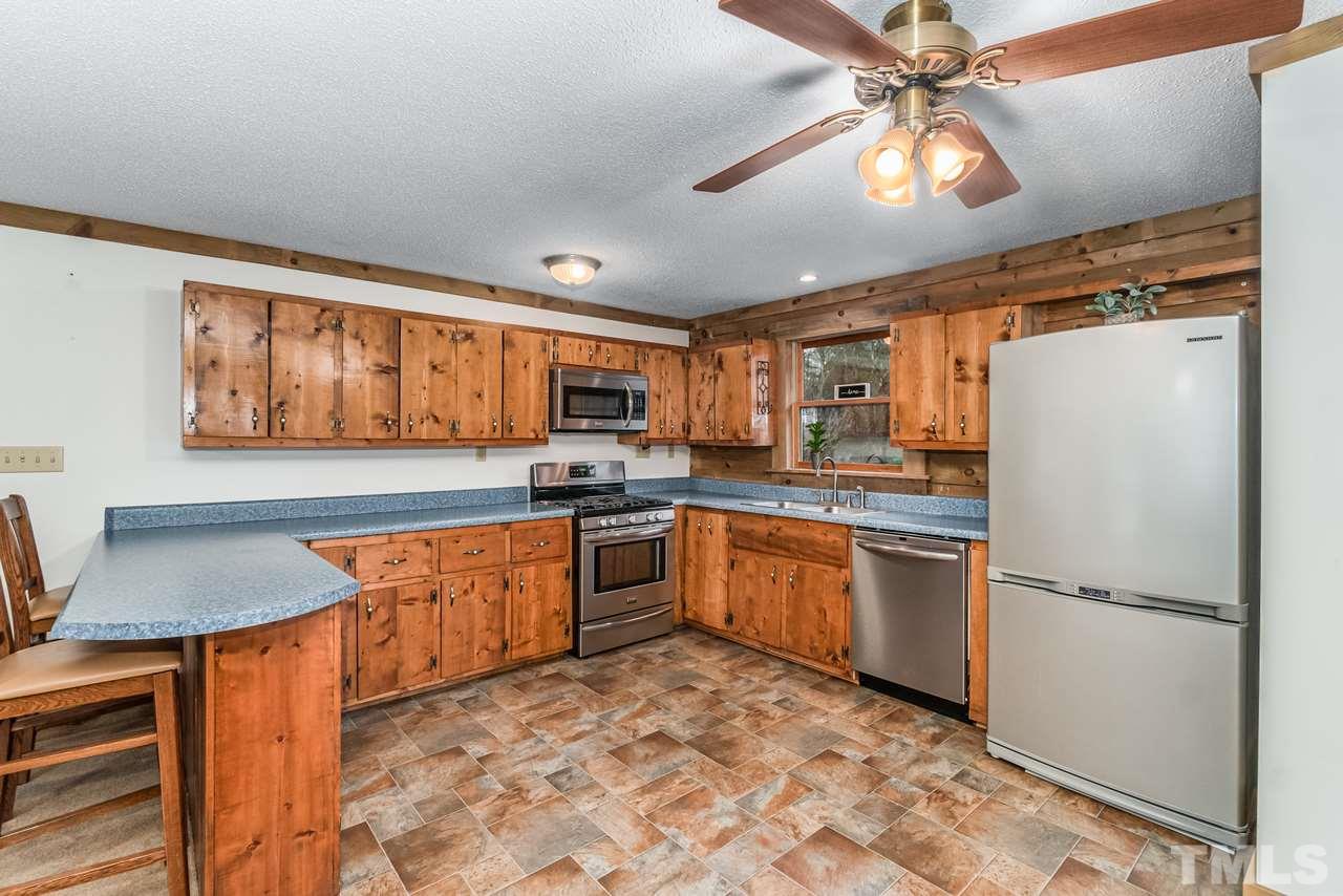 148 Nutbush Road Manson, NC 27553 - Photo 10 of 30 a kitchen with stainless steel appliances granite countertop a refrigerator a stove top oven a sink and dishwasher