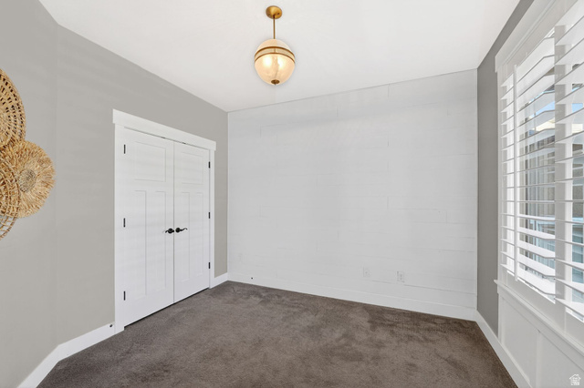 14714 South Bright Wood Road Herriman, UT 84096 - Photo 7 of 41 Unfurnished bedroom/office with multiple windows, dark carpet, and a closet