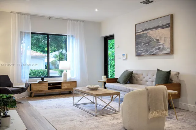 a living room with furniture and a large window