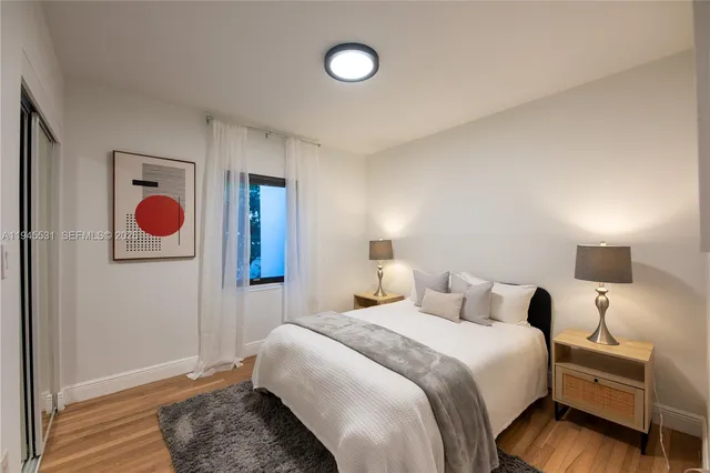 a bedroom with a bed and a lamp