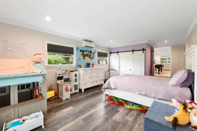 a bed room with furniture and a flat screen tv