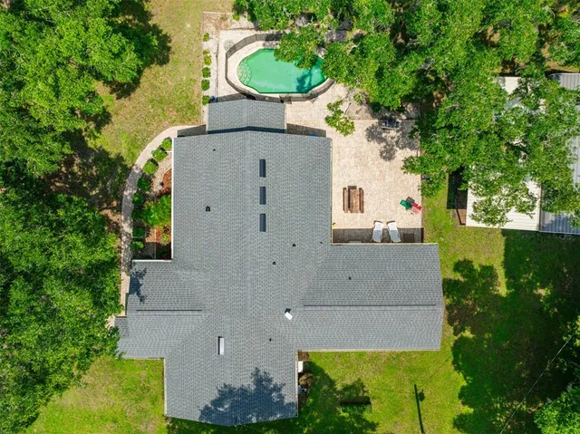 an aerial view of a house with a yard