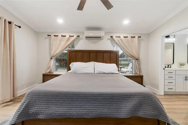 a bedroom with a large bed and a chandelier