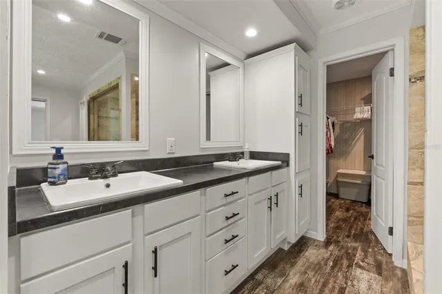 a spacious bathroom with a double vanity sink and mirror