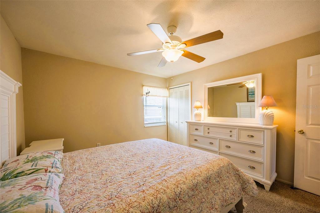6777 Winkler Road, Unit 150 Fort Myers, FL 33919 - Photo 21 of 48 a bedroom with a bed and a dresser