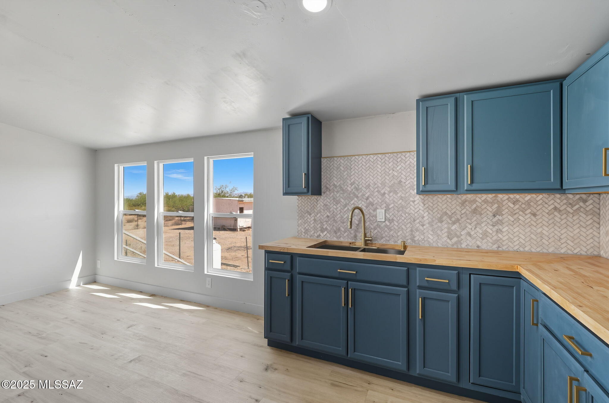 8790 North Trico Road Marana, AZ 85653 - Photo 9 of 35 a kitchen with stainless steel appliances granite countertop a sink stove and cabinets