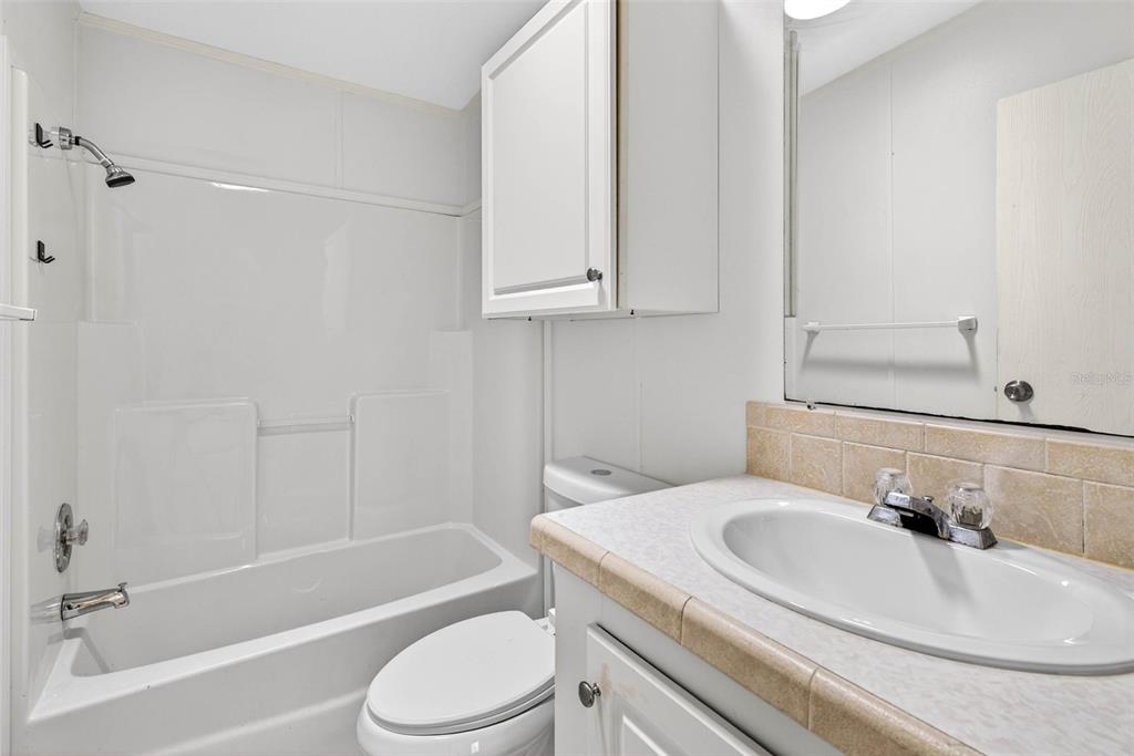 6781 West Grant Street Homosassa, FL 34448 - Photo 16 of 24 a bathroom with a granite countertop sink toilet and shower